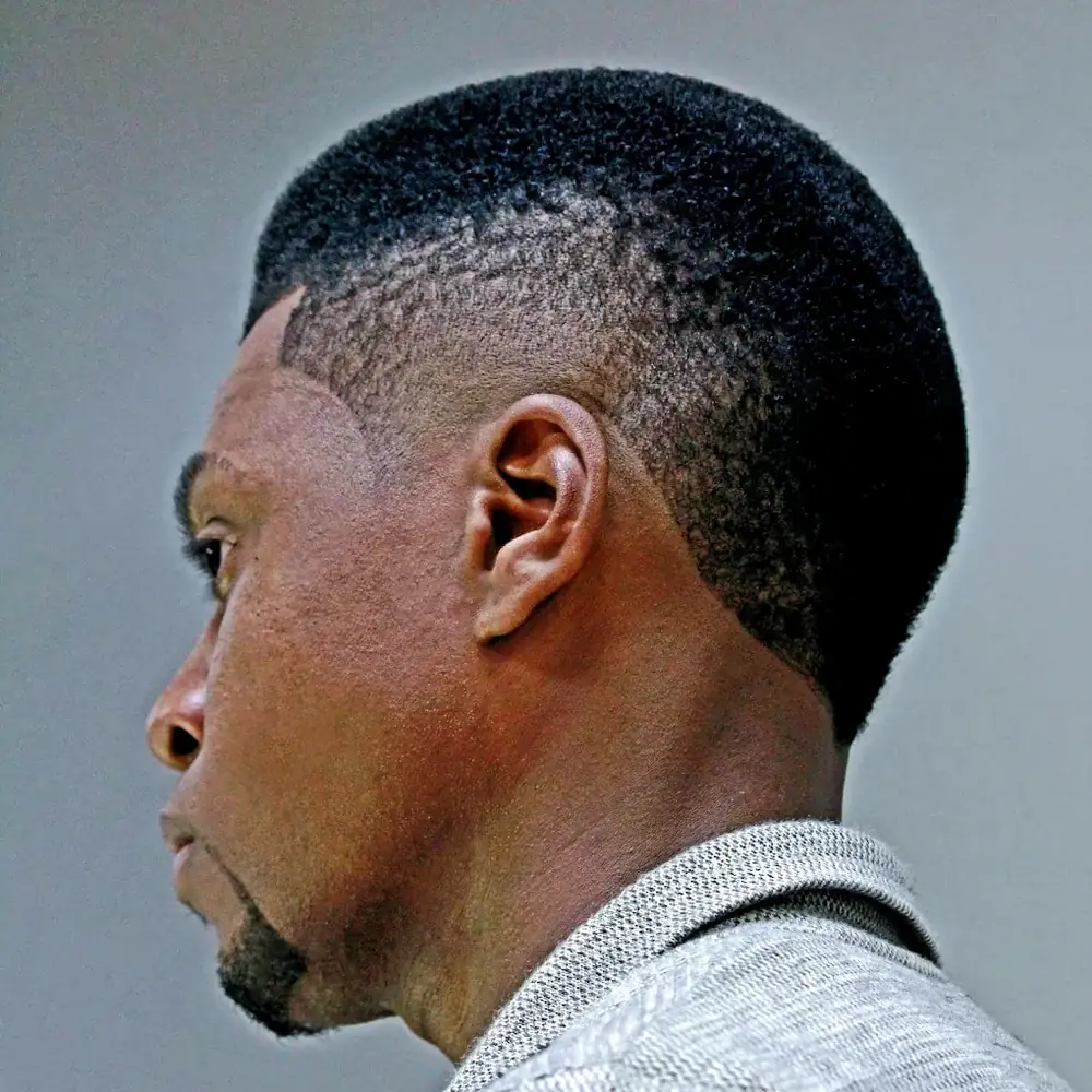 Side profile of a man with a short skin fade and a lined-up hairline